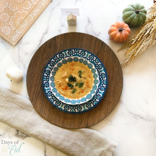 Creamy chicken and vegetable soup plated on mosaic pattern plates