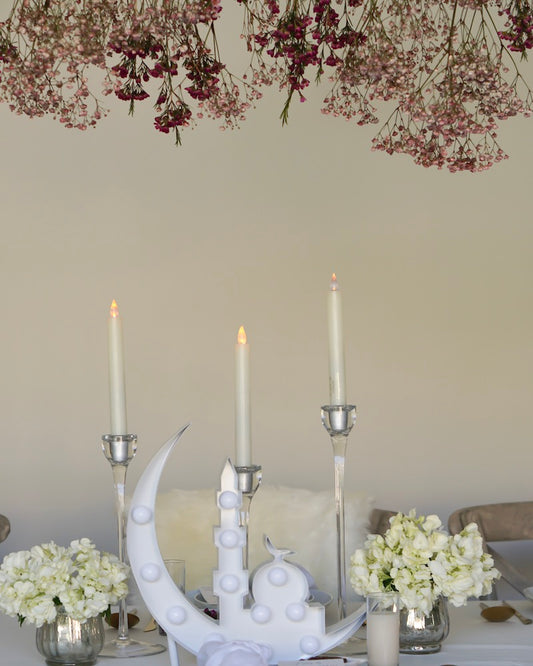 white tablescape with crescent mosque marquee and silver candlesticks